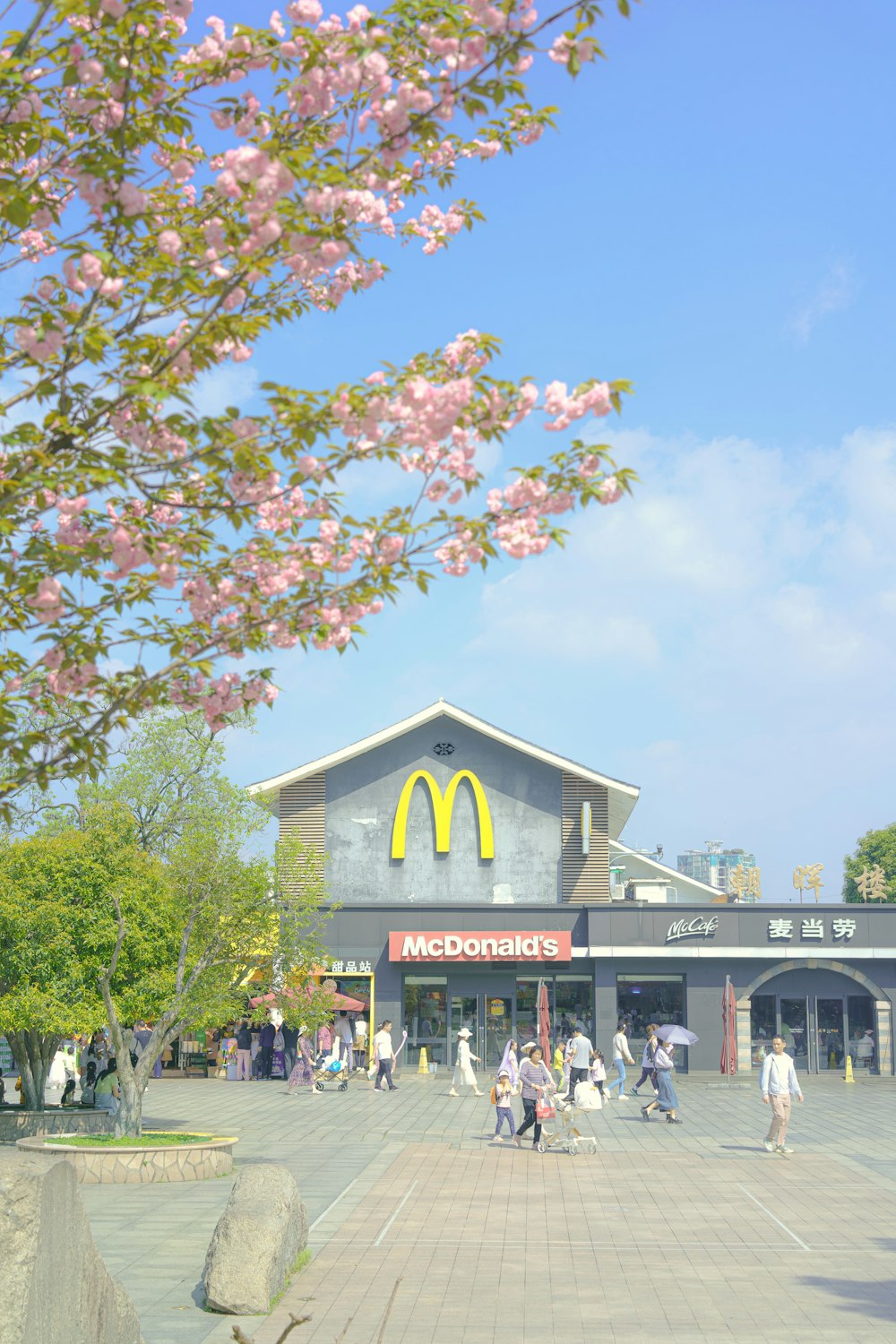 a mcdonald's restaurant with a lot of people walking around
