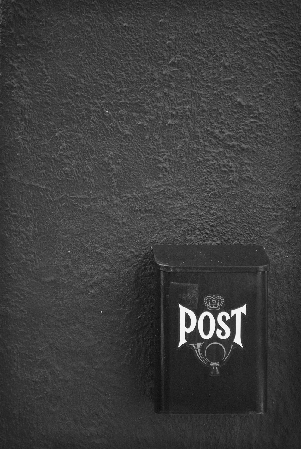 a black and white photo of a post box