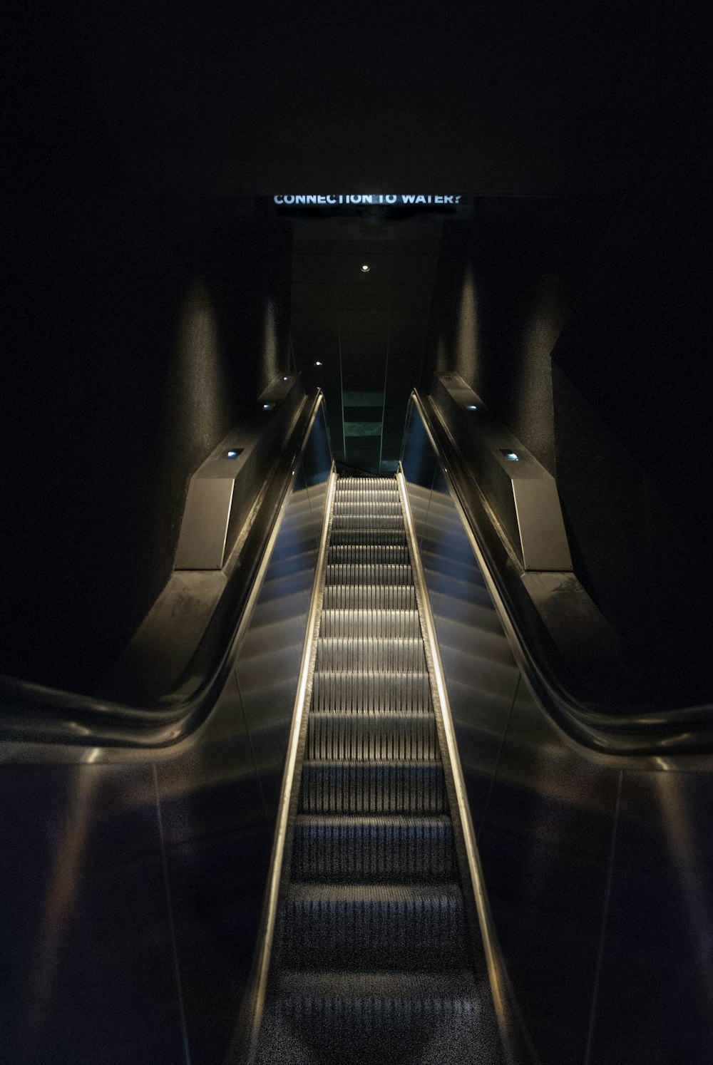 an escalator in a subway station at night