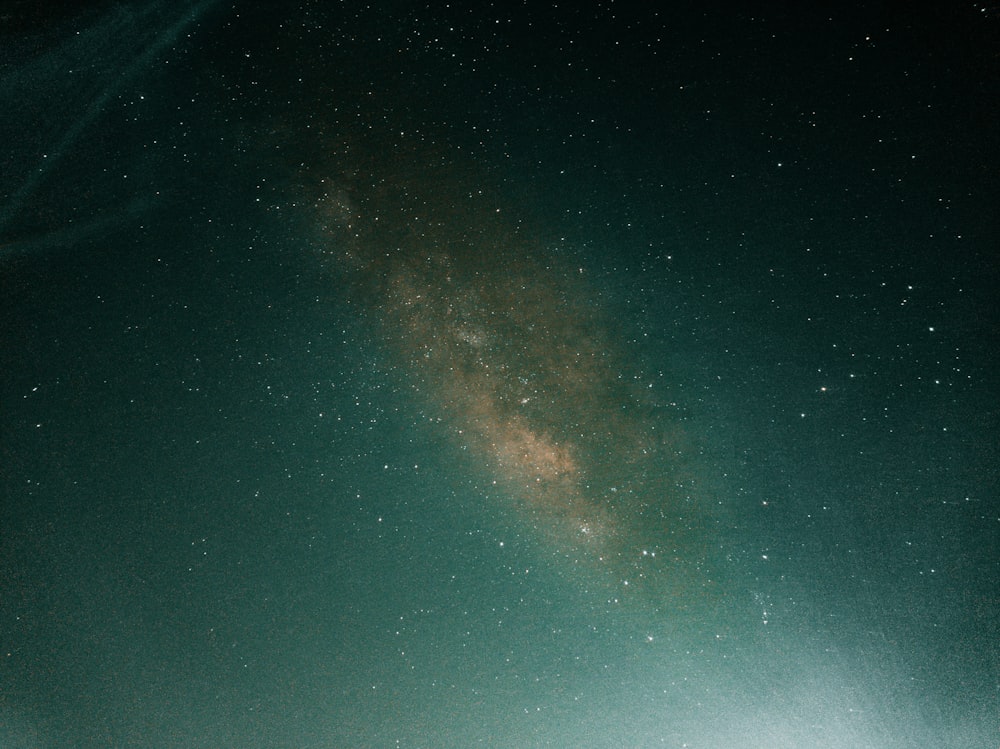 a person standing on a hill under a night sky