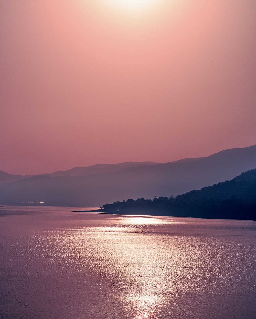 a large body of water with mountains in the background