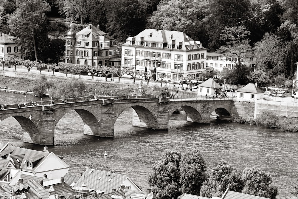 a black and white photo of a bridge over a river