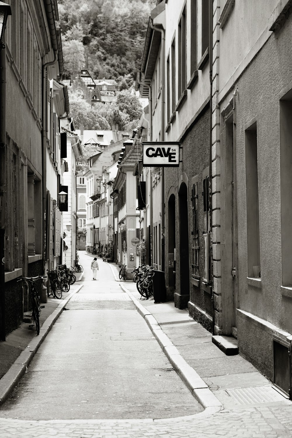 a black and white photo of a narrow street