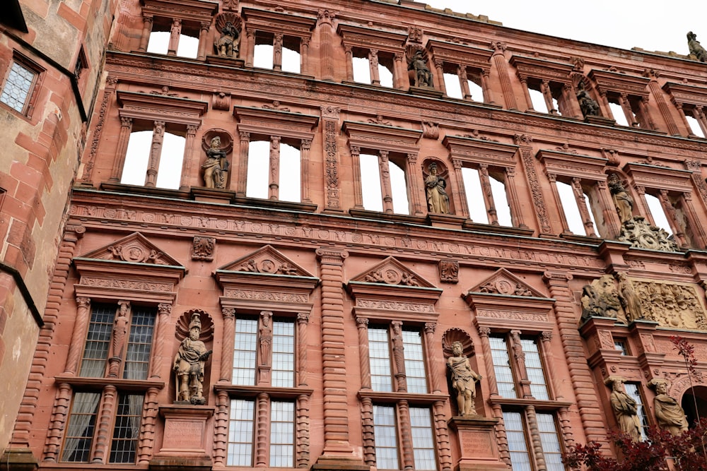 a building with many windows and statues on the side of it