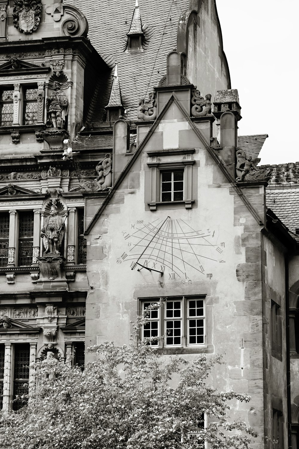 a black and white photo of a building with a clock on it