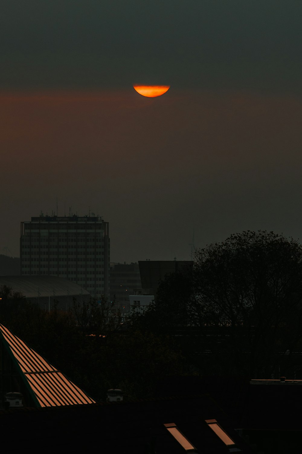 the sun is setting over a city skyline