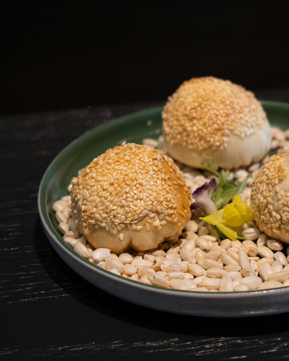 a plate of food with sesame seed buns on it