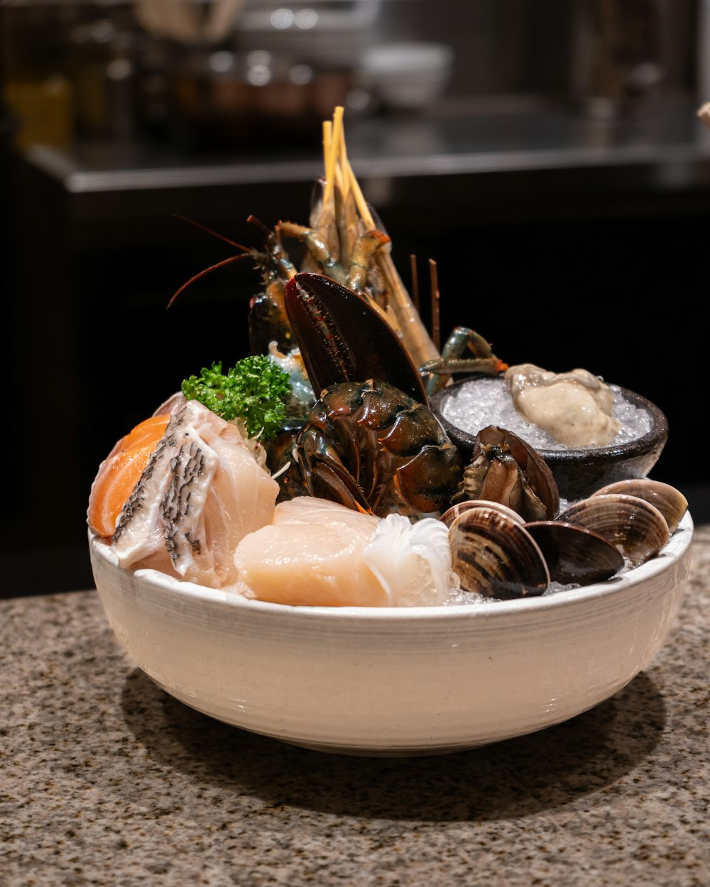 a bowl filled with seafood on top of a counter