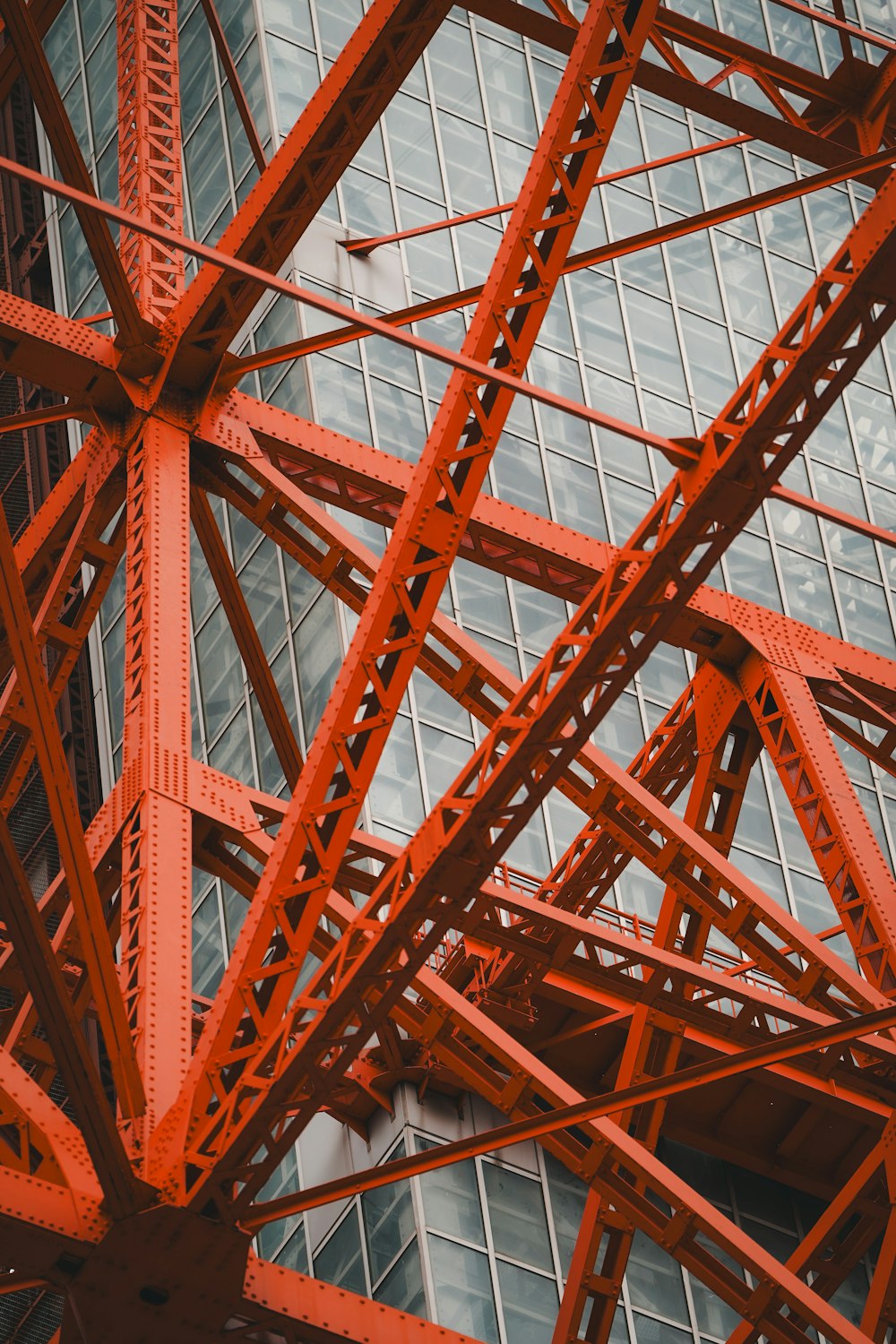 a close up of a red metal structure near a building
