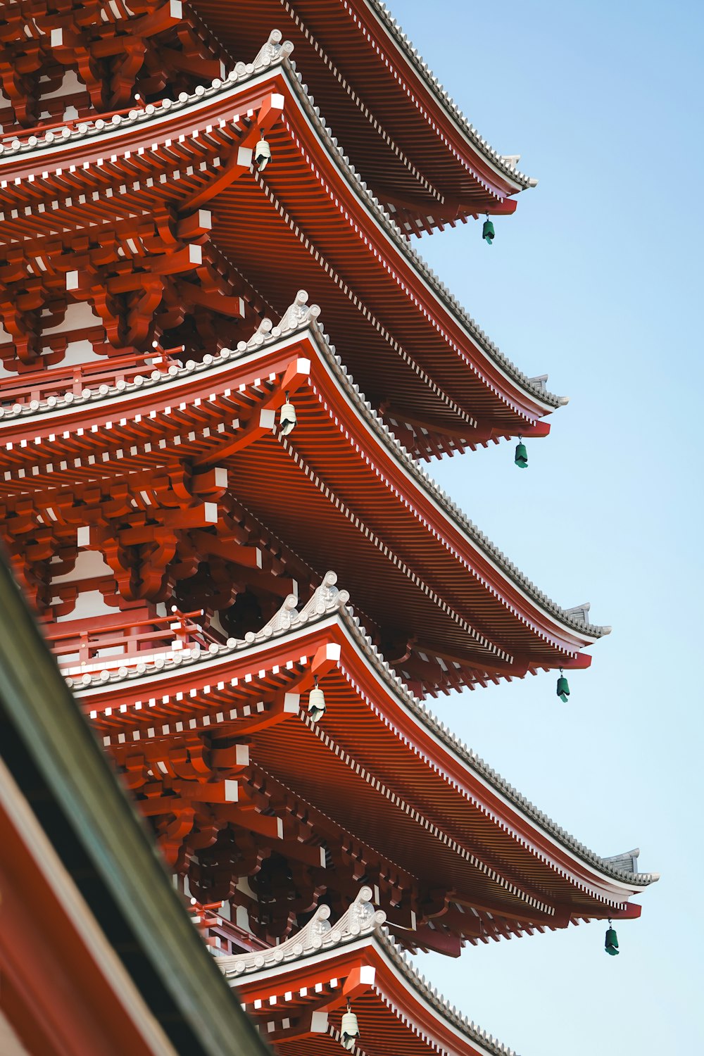 a tall red building with a sky in the background