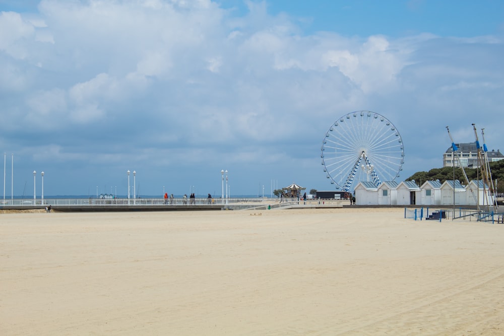 a large ferris wheel sitting on top of a sandy beach