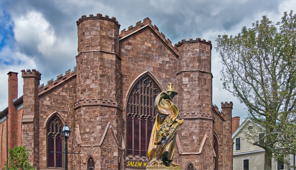 a large building with a statue in front of it