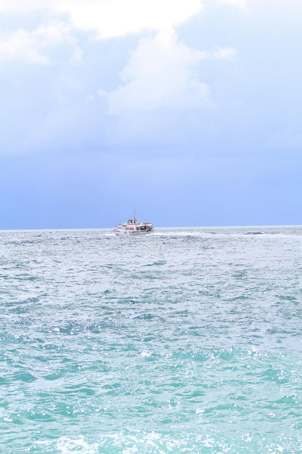 a small boat in the middle of a large body of water