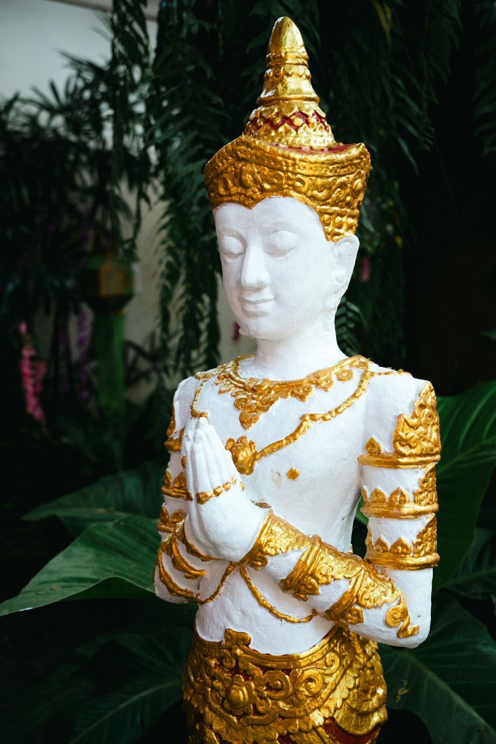 a statue of a person dressed in gold