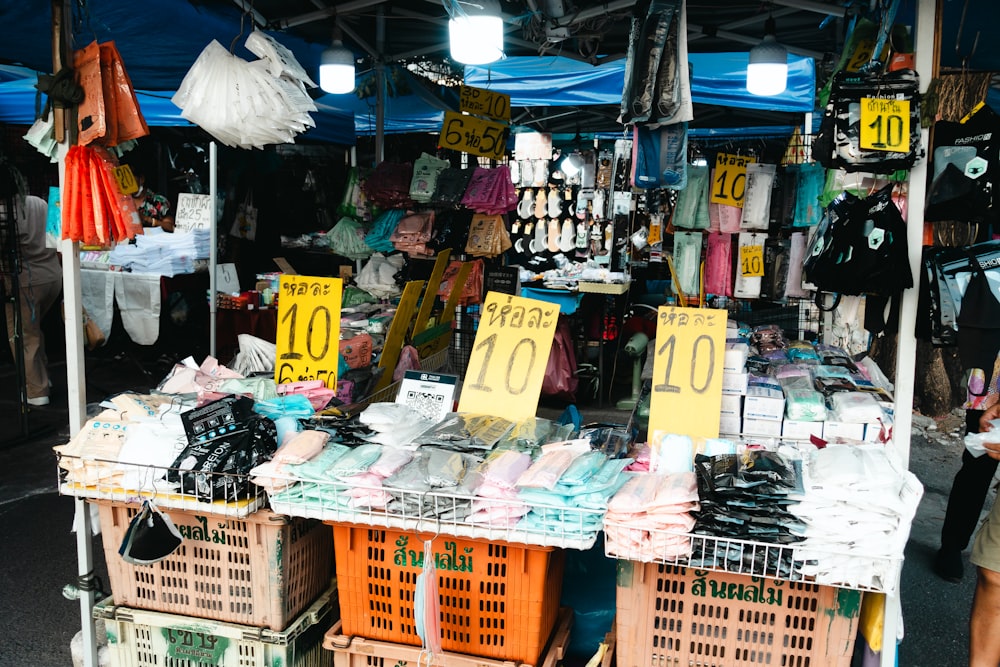 a woman standing in front of a market stall