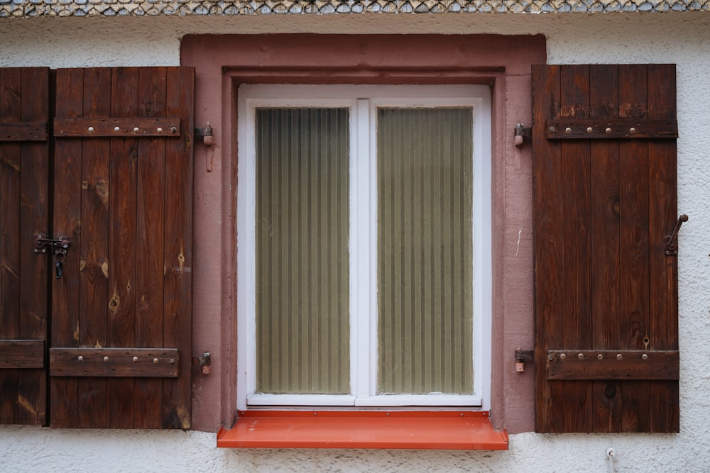 a close up of a window with wooden shutters