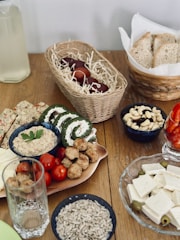 a wooden table topped with plates of food