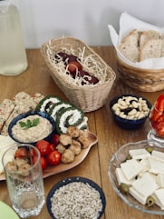 a wooden table topped with plates of food