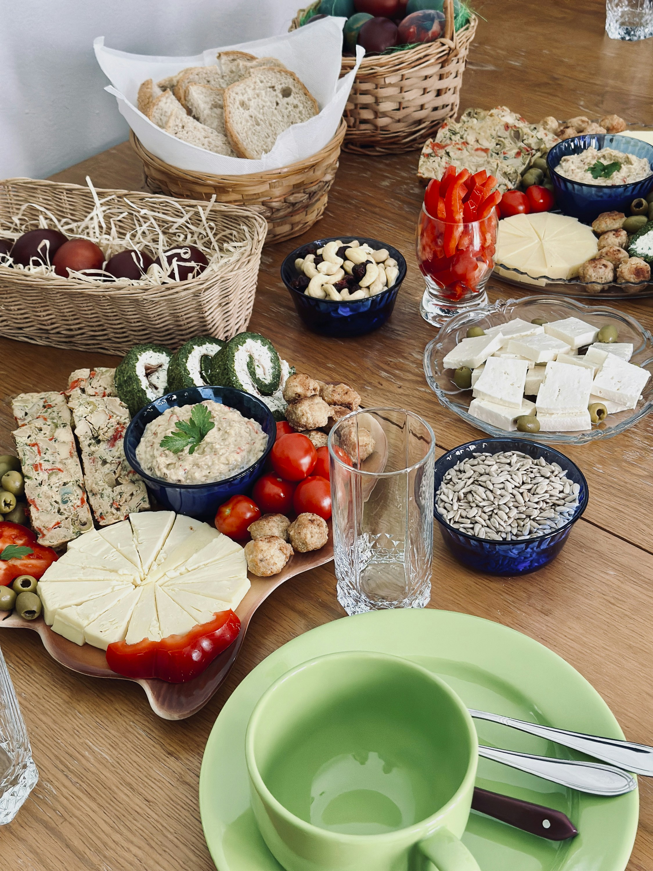 a wooden table topped with plates and bowls of food