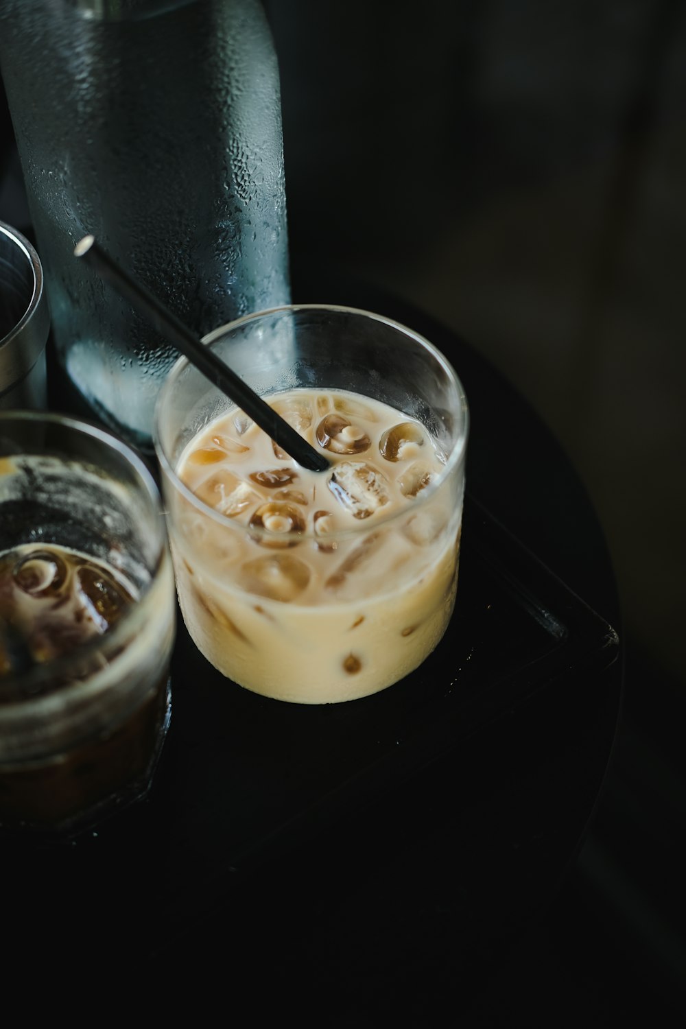 a glass of liquid with a spoon next to it