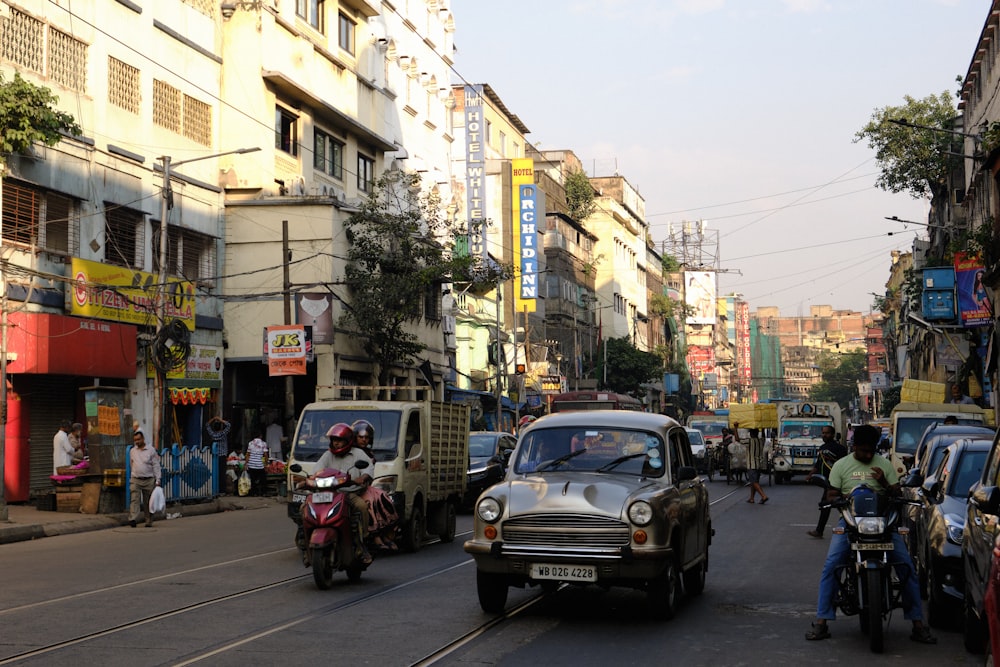 a busy city street with cars and motorcycles