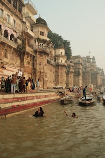 Devotees taking a holy dip in the River Ganga at Varanasi ghats during sunrise prayers.
