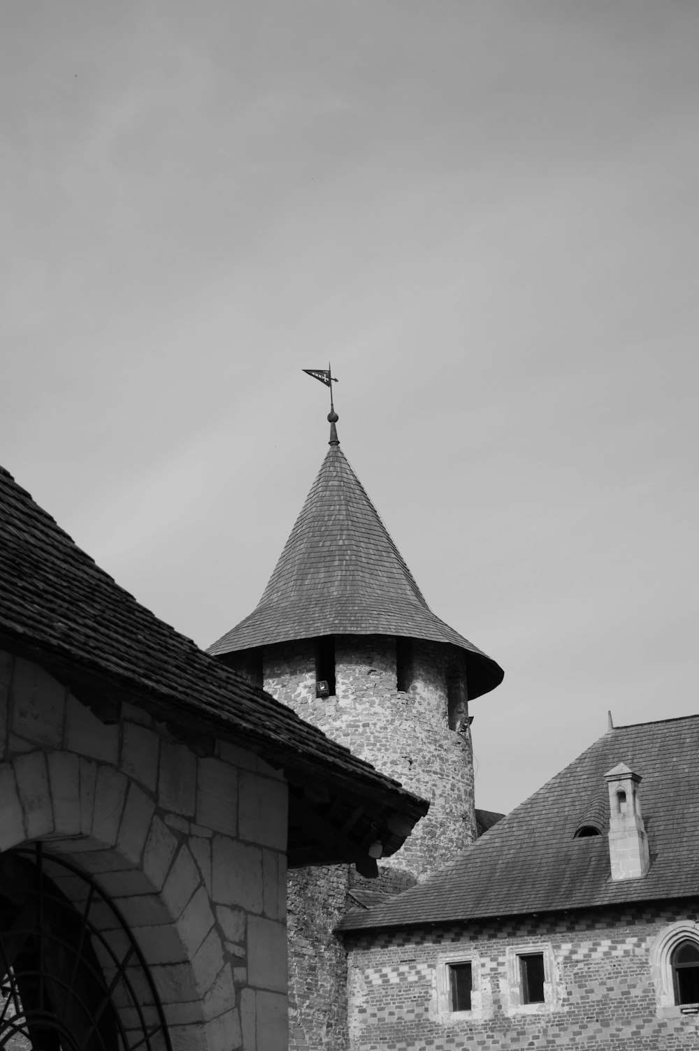 a black and white photo of a building with a cross on top