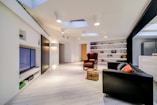 a living room filled with furniture and a flat screen tv