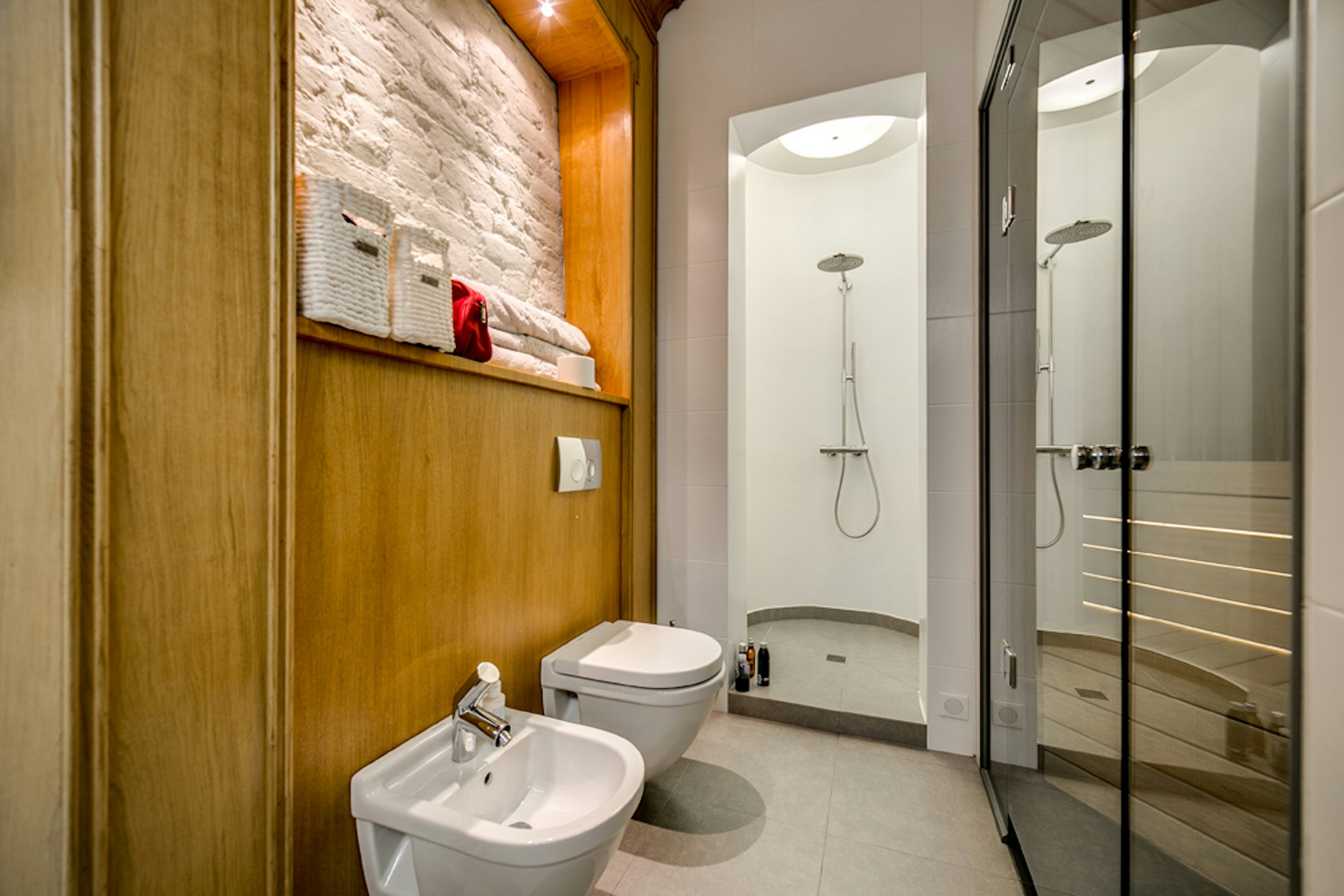 Bathroom with dual toilets and shower