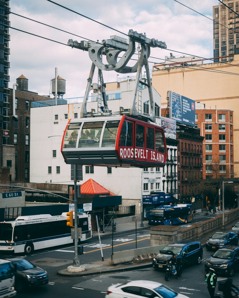 a red cable car on a city street