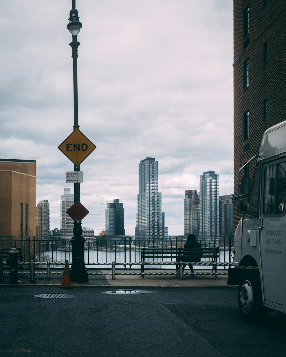 a white truck parked next to a street sign