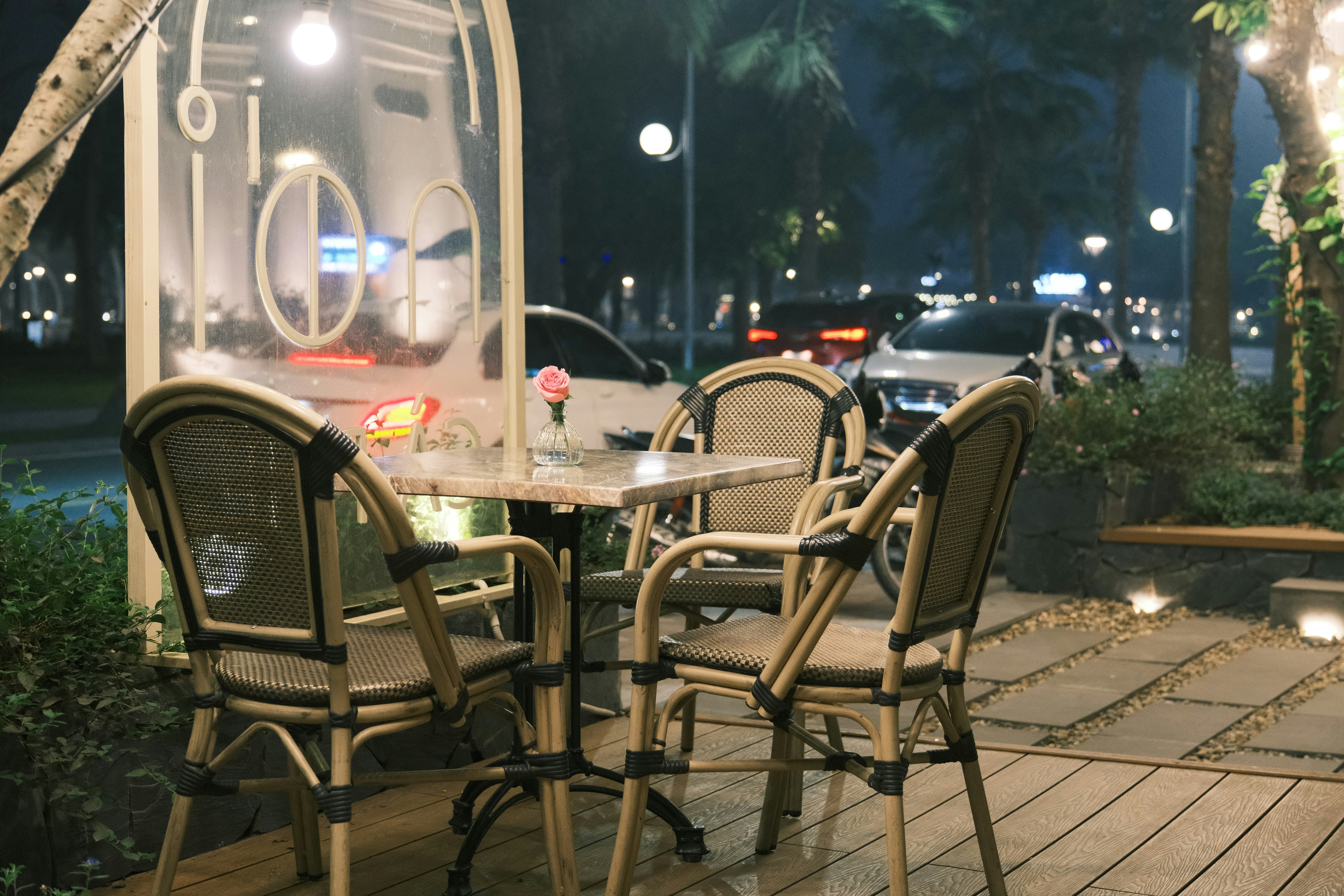 a table and chairs on a patio at night
