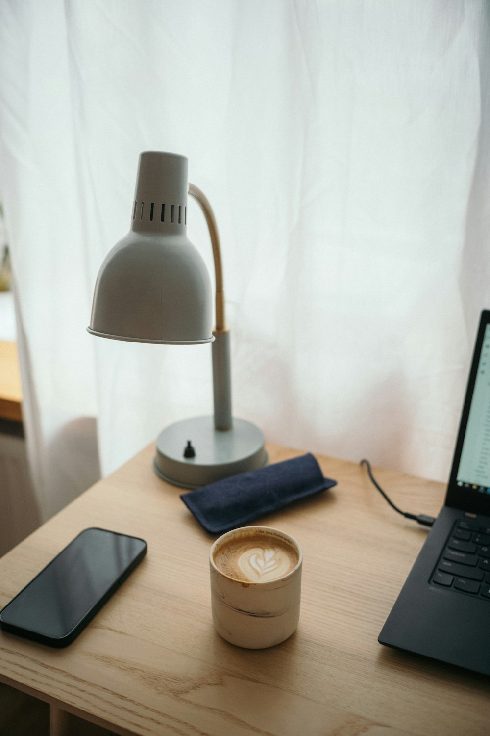 a laptop computer sitting on top of a wooden desk