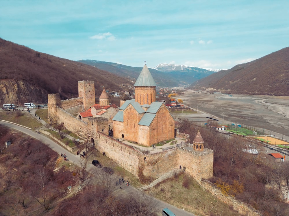 an aerial view of a castle in the mountains