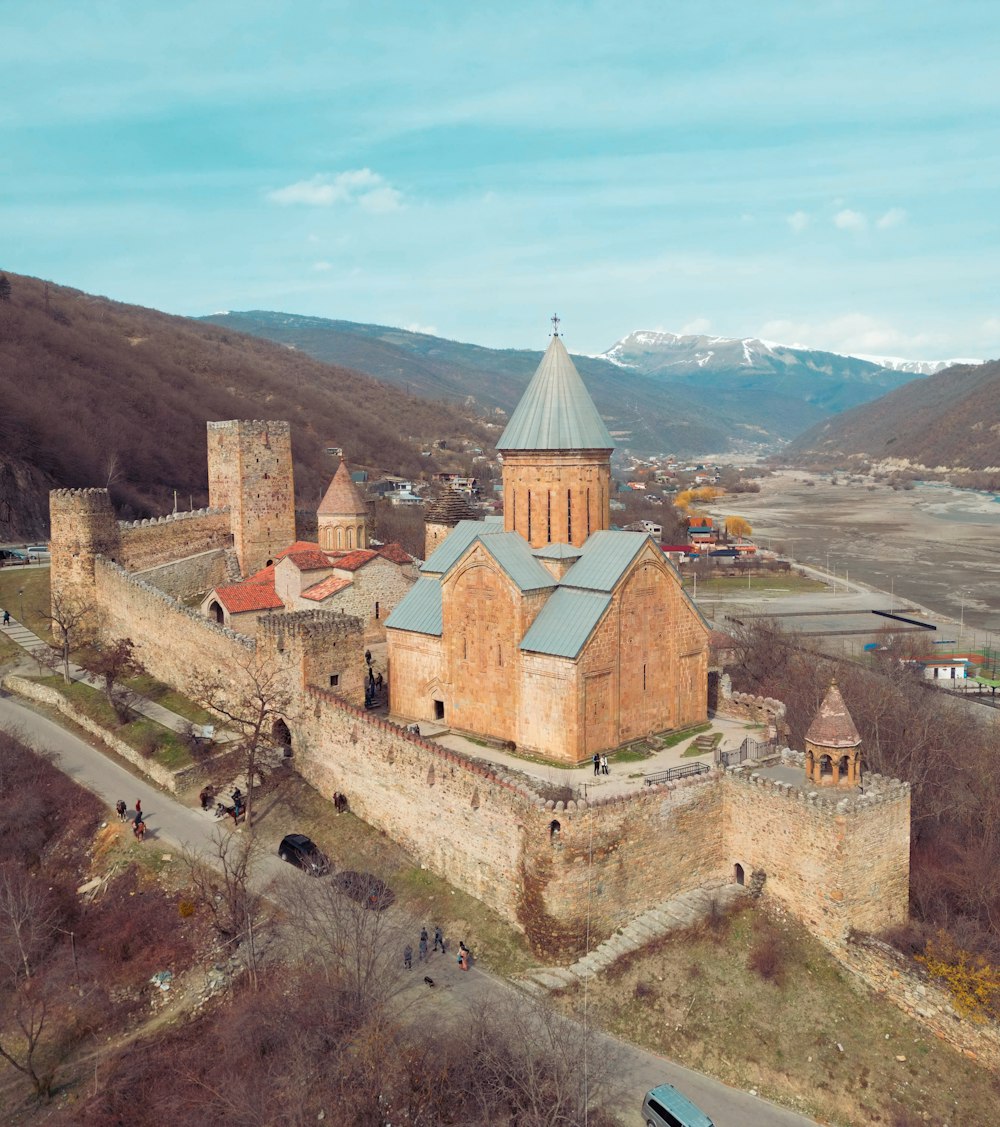 an aerial view of a castle in the mountains