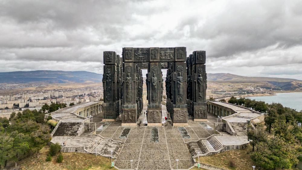 an aerial view of a monument with a lake in the background