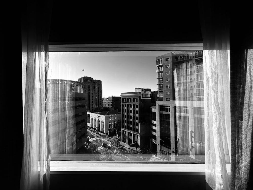 a black and white photo of a city from a window