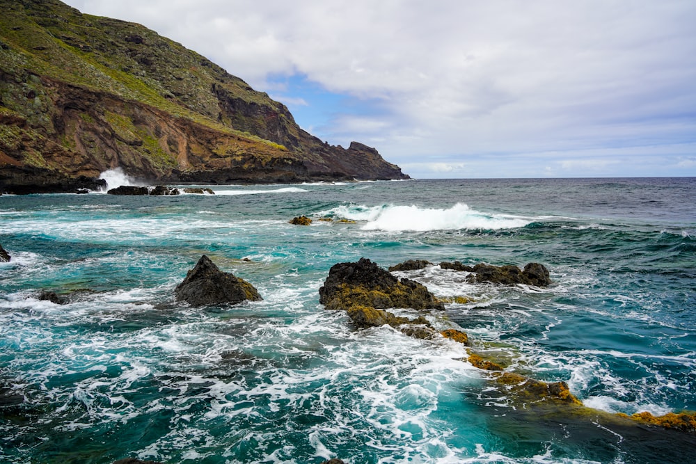 a body of water near a rocky shore