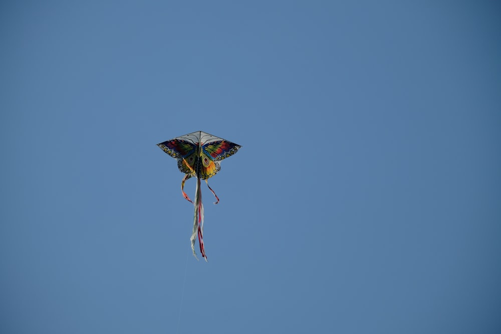 a kite flying high in the sky on a clear day