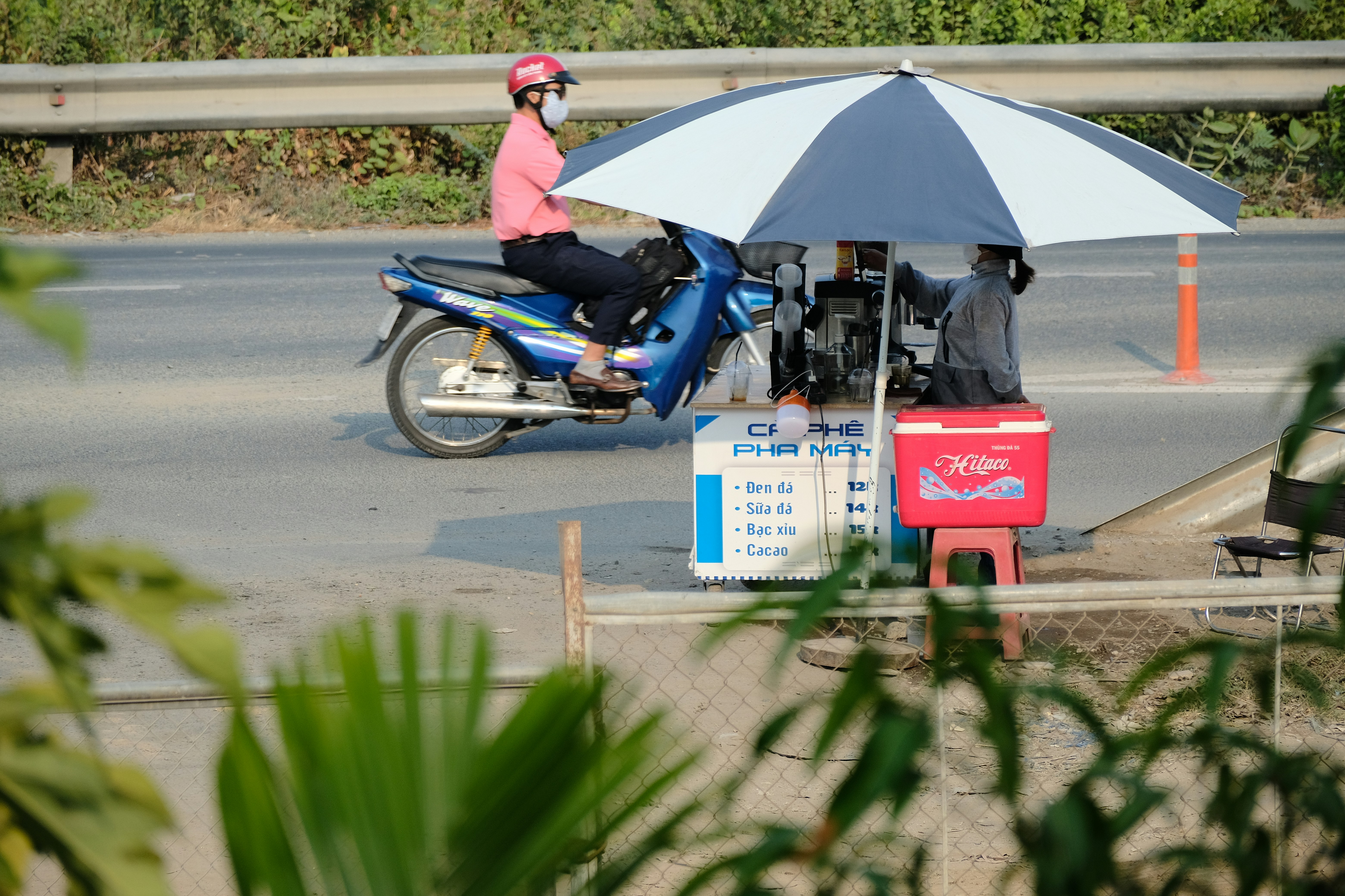 a person on a motor bike with an umbrella