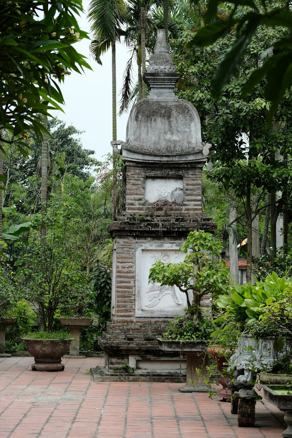 a brick tower with a statue on top of it