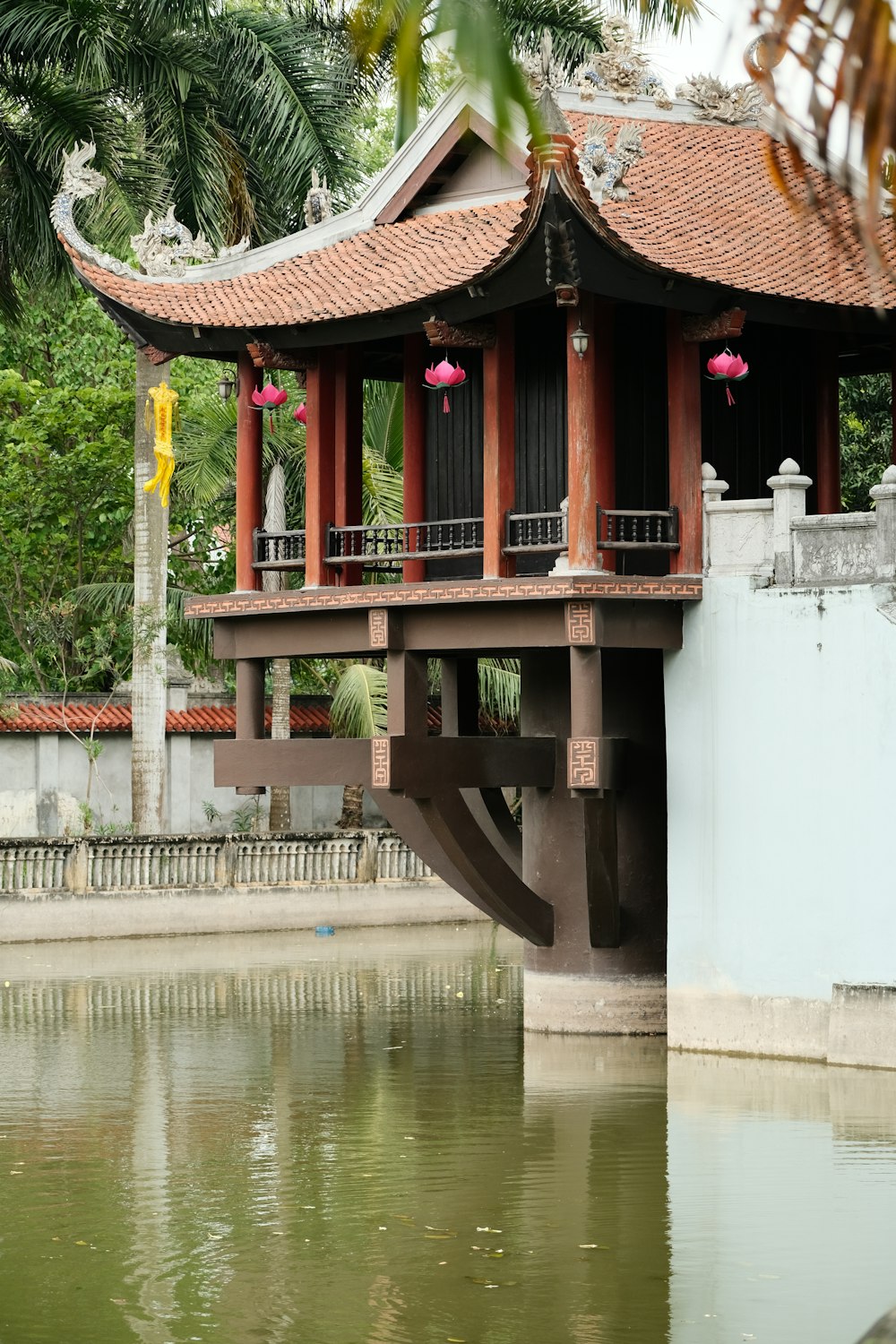 a bridge over a body of water with a building in the background