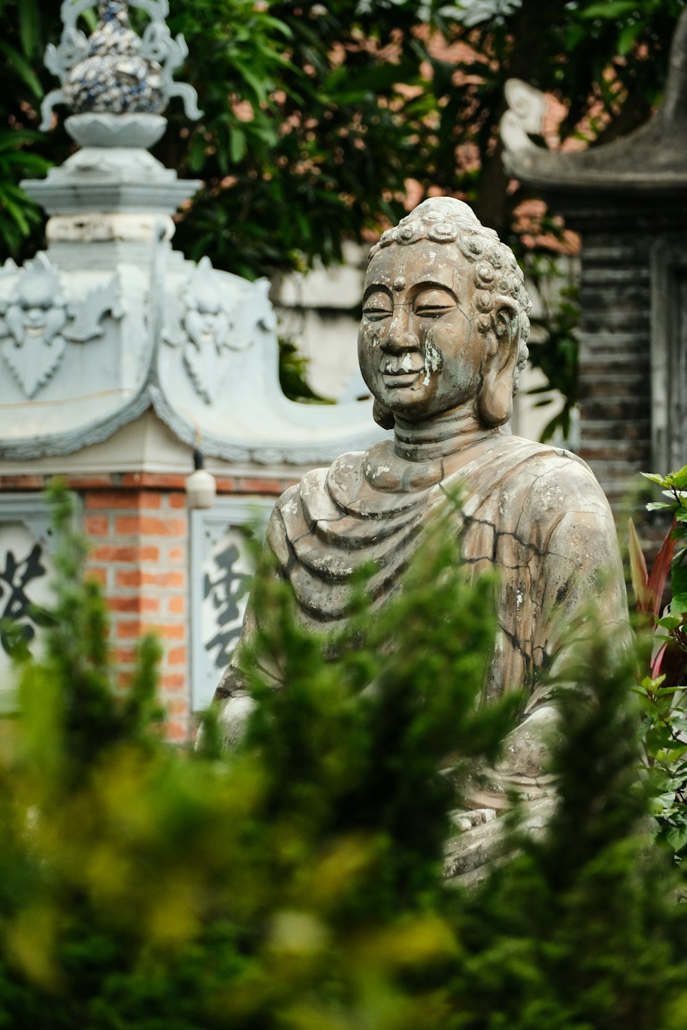 a statue of a buddha in a garden
