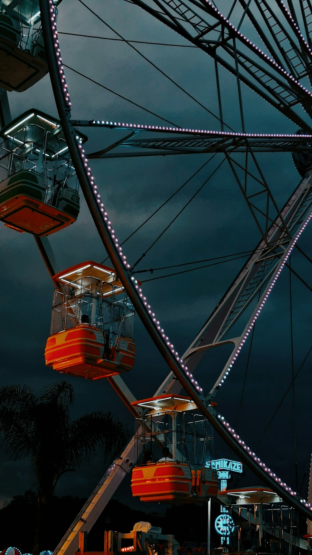 a ferris wheel at night with lights on it