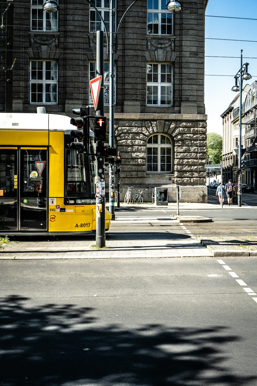 a yellow bus stopped at a traffic light