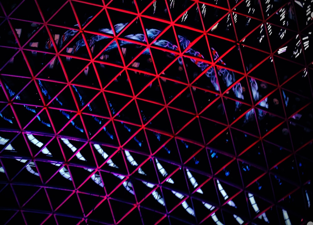 a close up of a metal structure with red lines