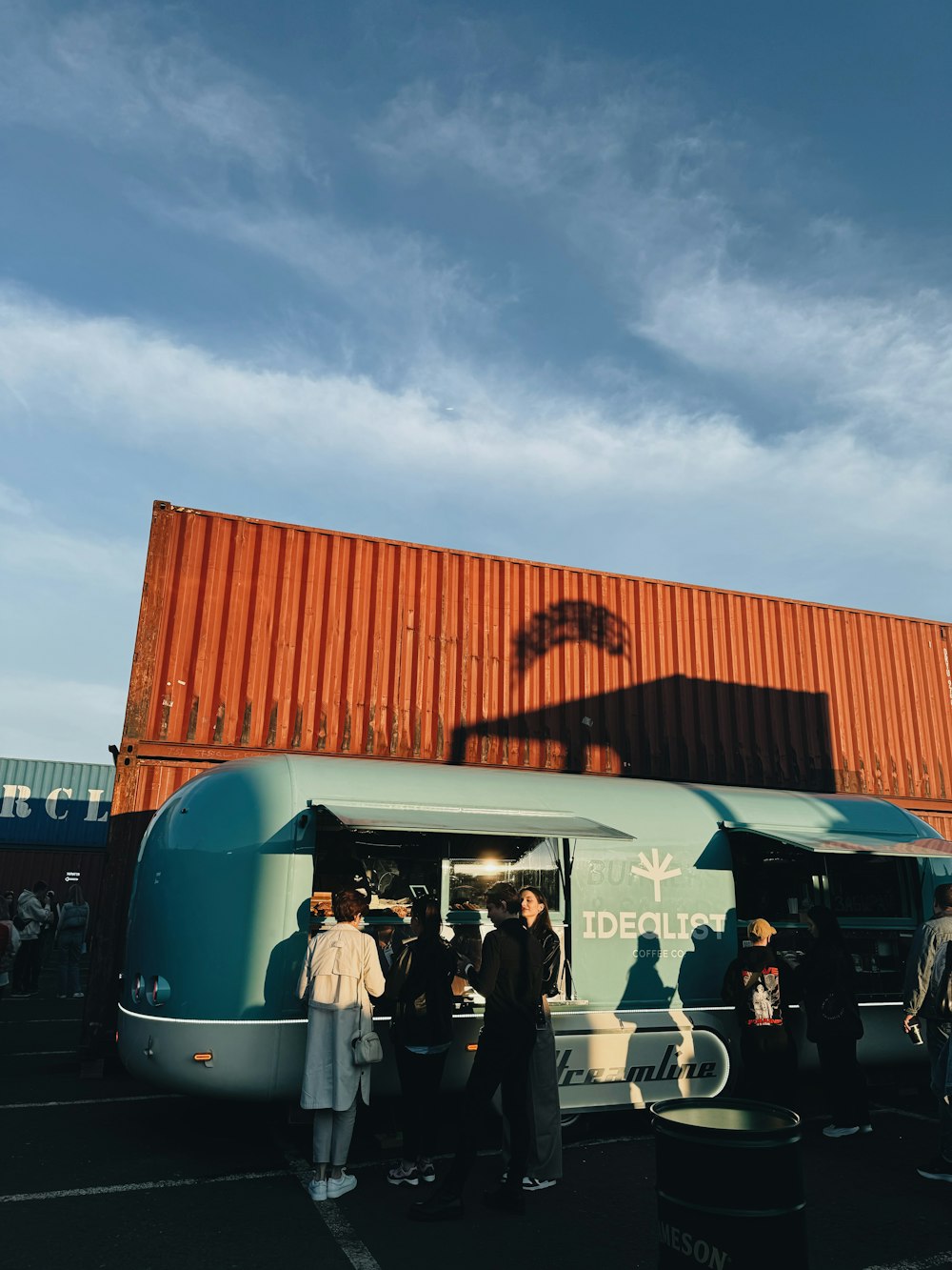 a group of people standing in front of a food truck