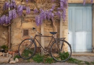 a bicycle parked in front of a stone building