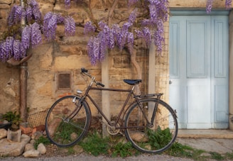 a bicycle parked in front of a stone building