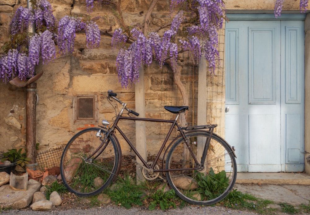 a bicycle parked in front of a stone building